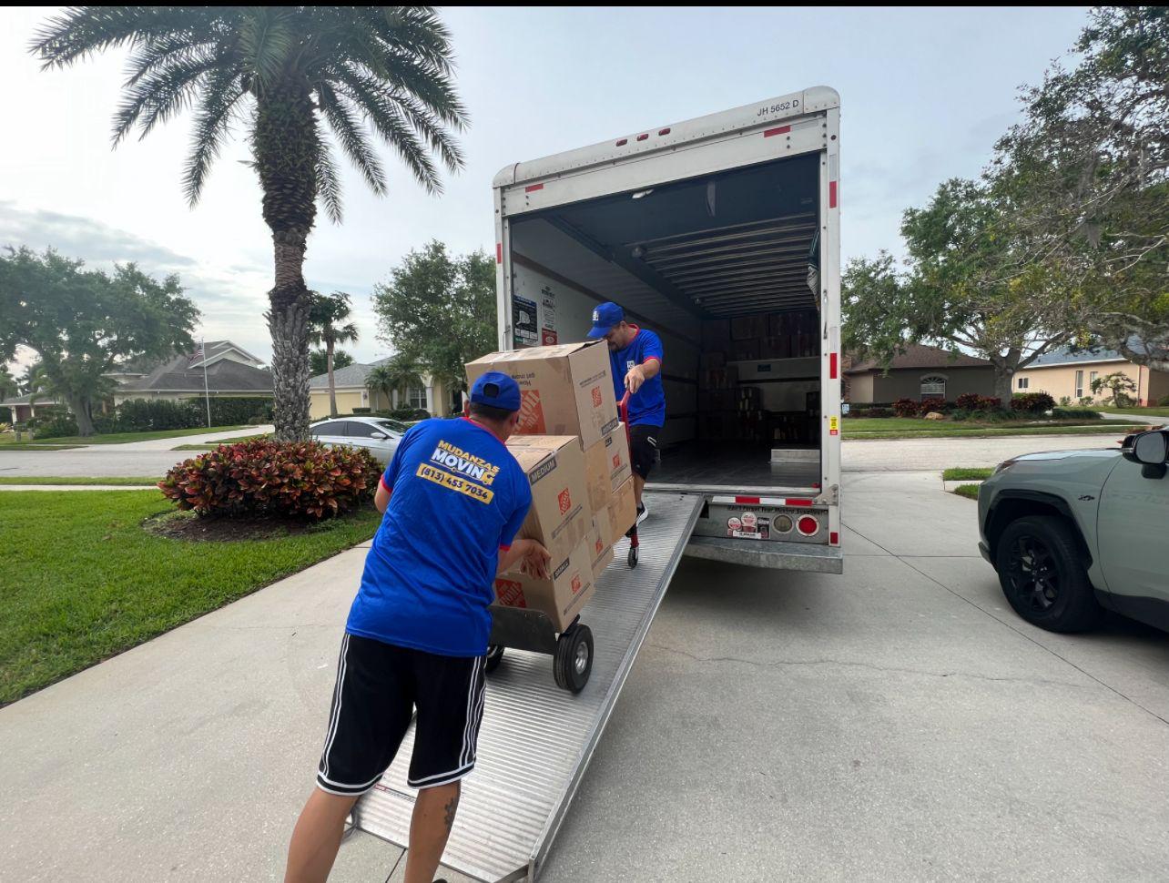 Movers loading Home Depot boxes into a moving truck in Tampa Bay